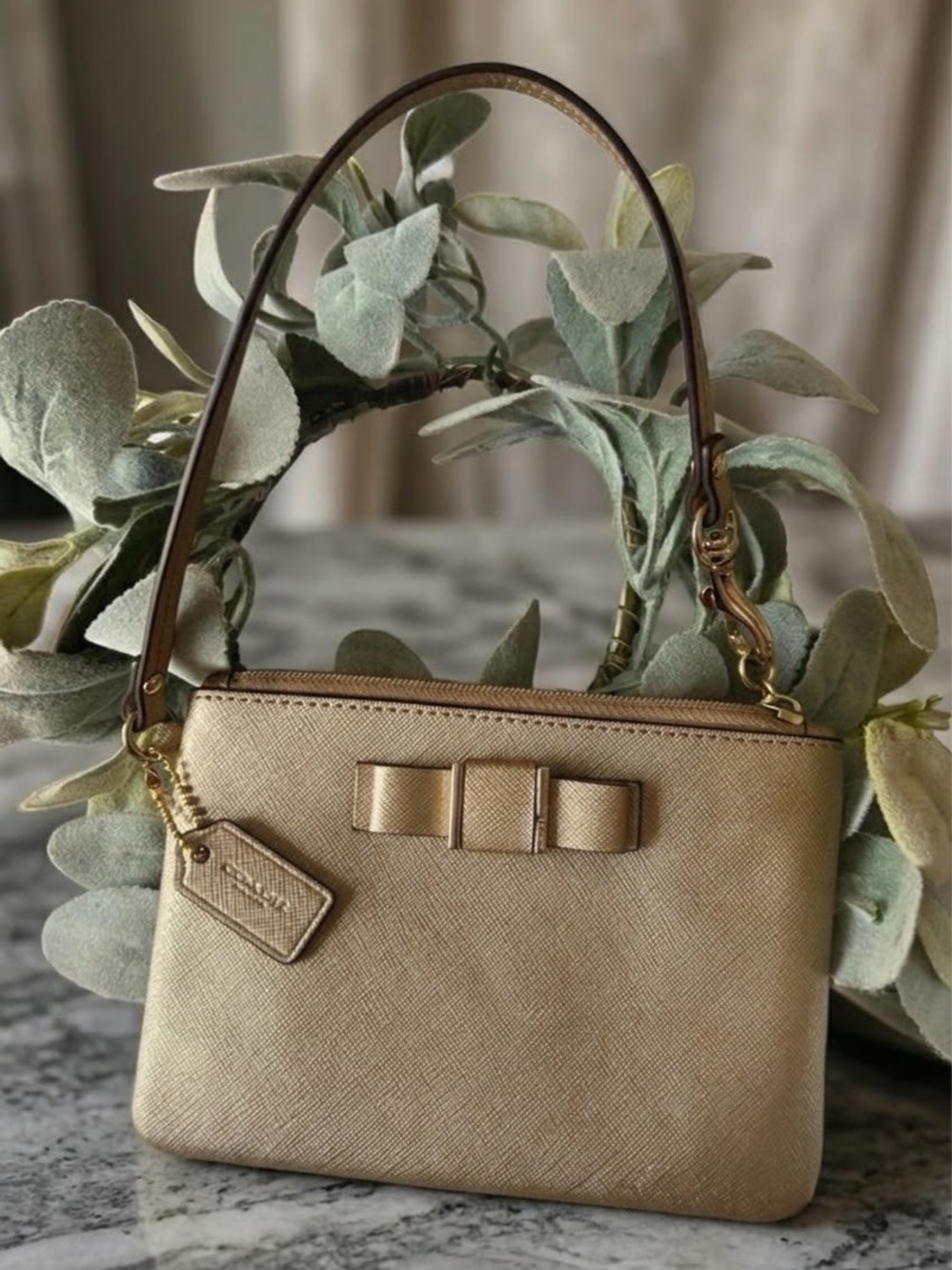 Coach Darcy Bow Wristlet (Style F51672) in metallic gold Saffiano Leather